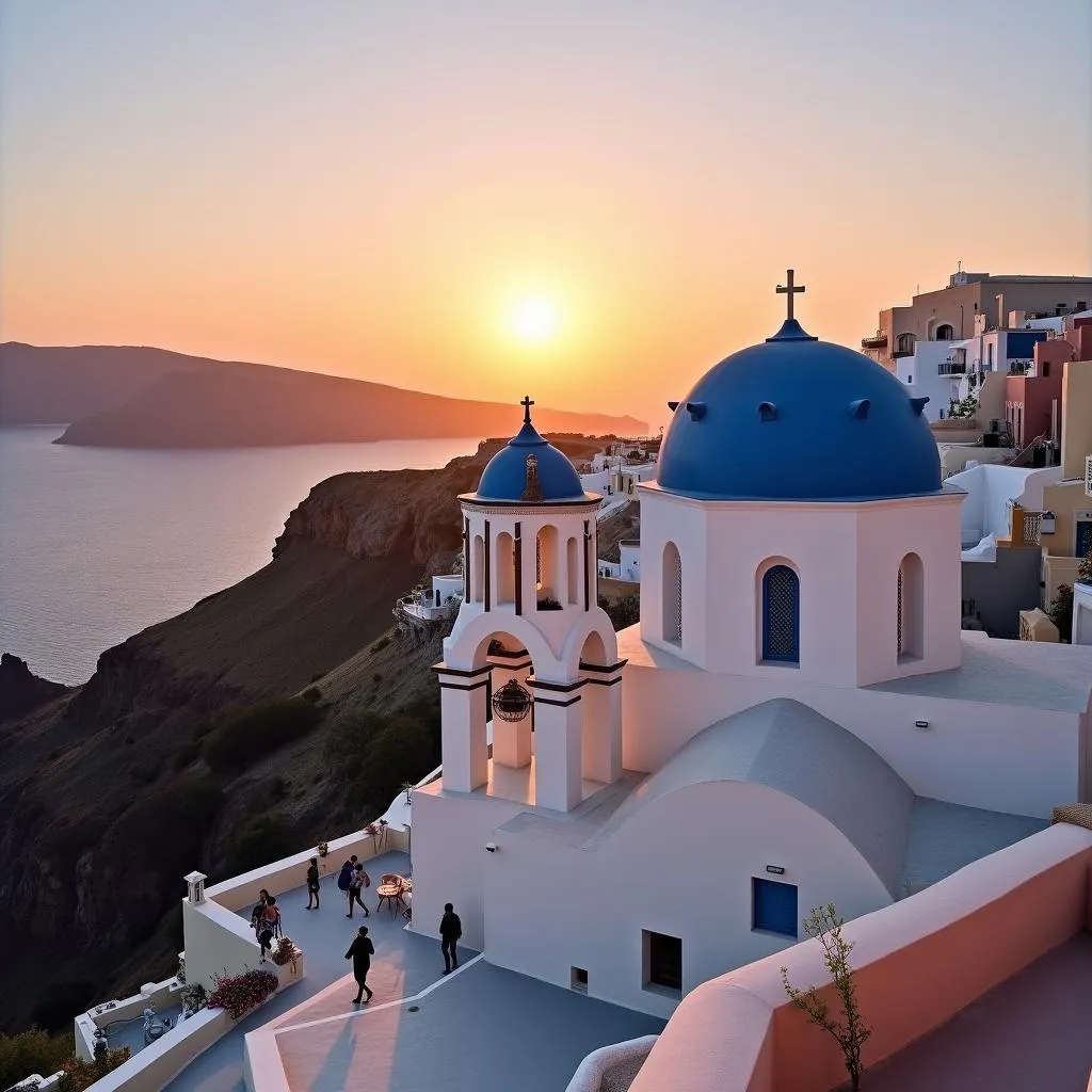 Oia village at sunset with colorful sky and white houses