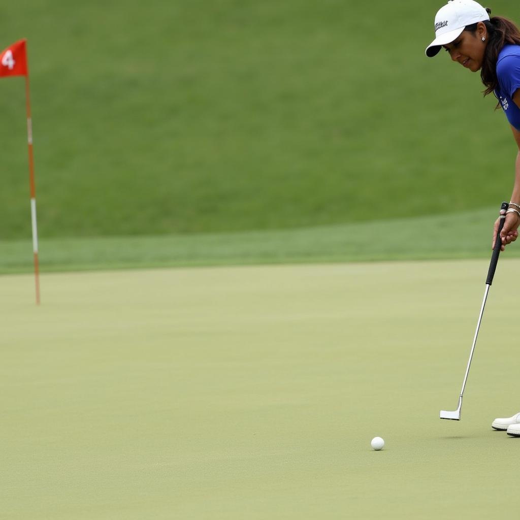 Aditi Ashok practices her putting on the green.