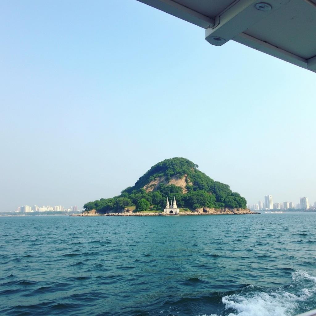 Panoramic view of Elephanta Island from the ferry, showcasing the surrounding waters and distant city skyline