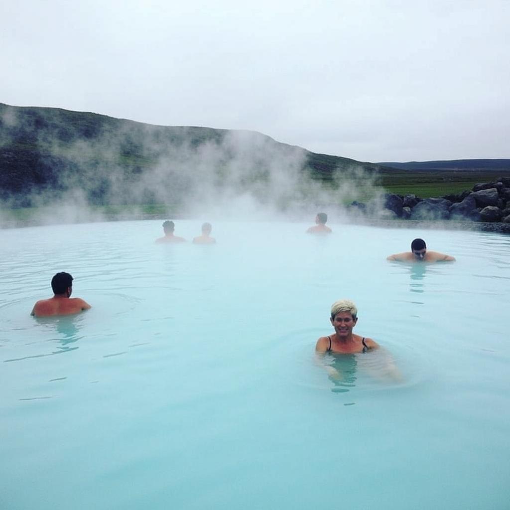 Myvatn Nature Baths Relaxation: Tourists enjoying the geothermal waters of the Myvatn Nature Baths in Iceland, with steam rising around them.